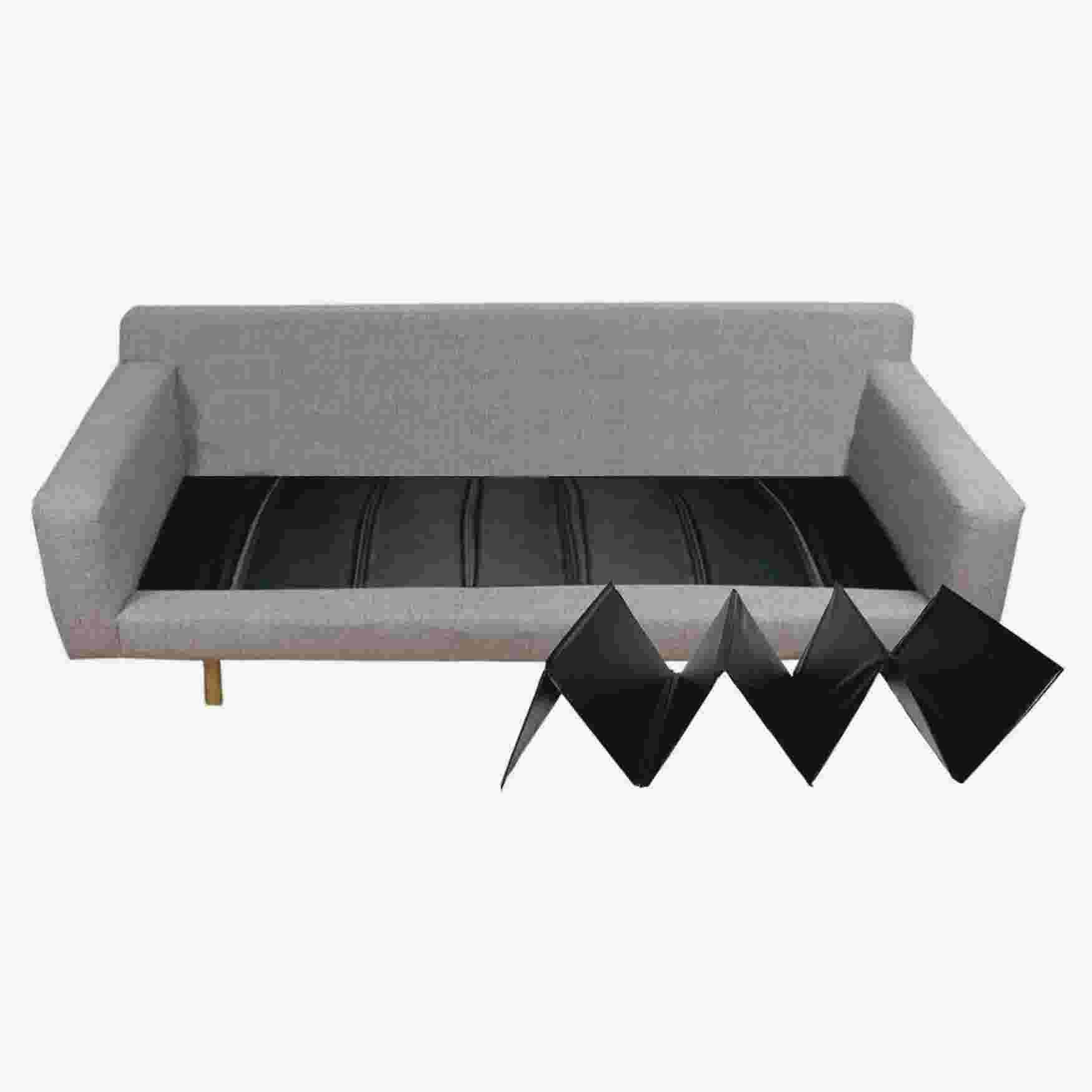 A black sofa cushion support on a gray sofa, with the support shown separately.